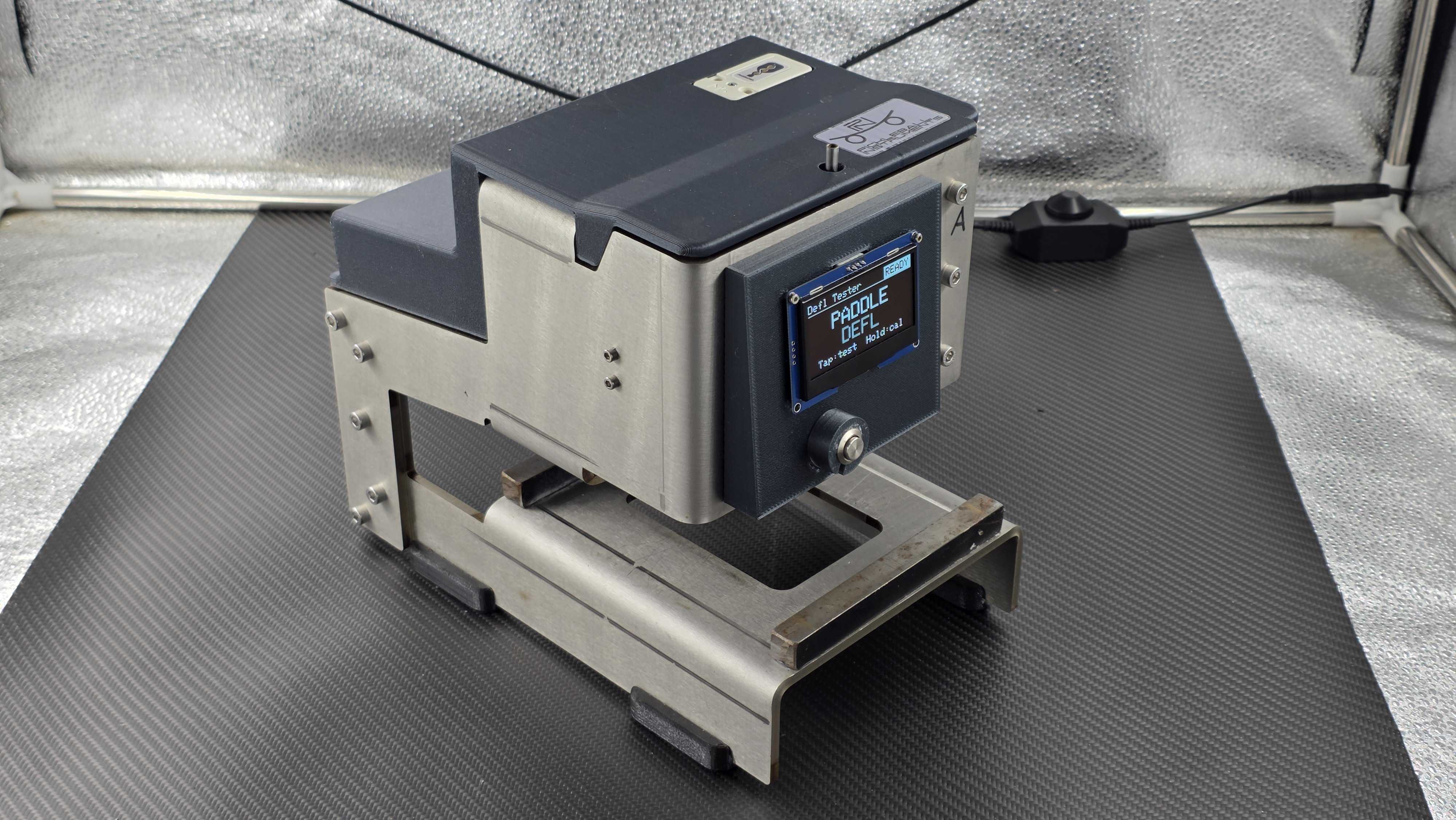 Rear three-quarter view of the deflection testing instrument